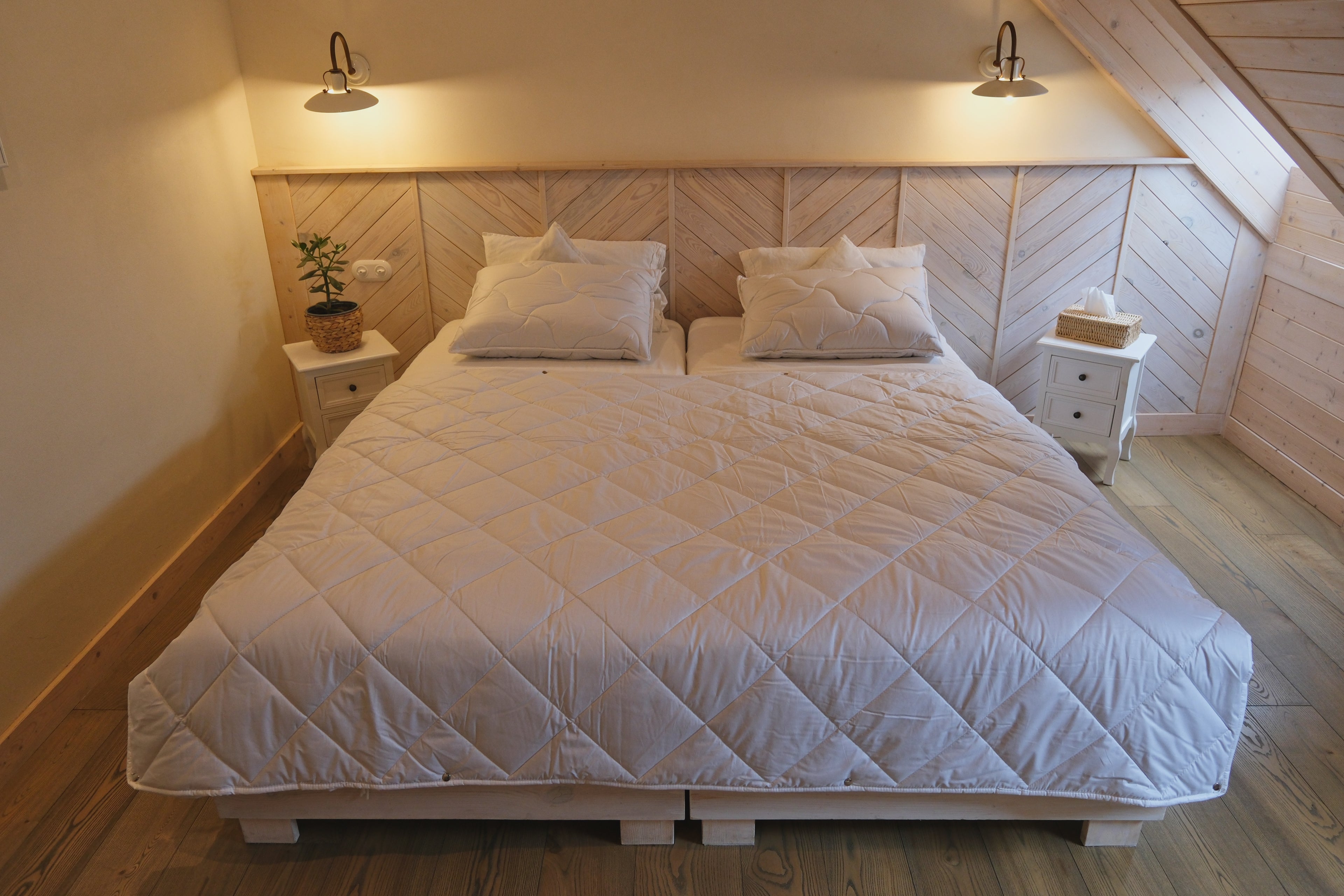 Bedroom with a wooden headboard and white bedding